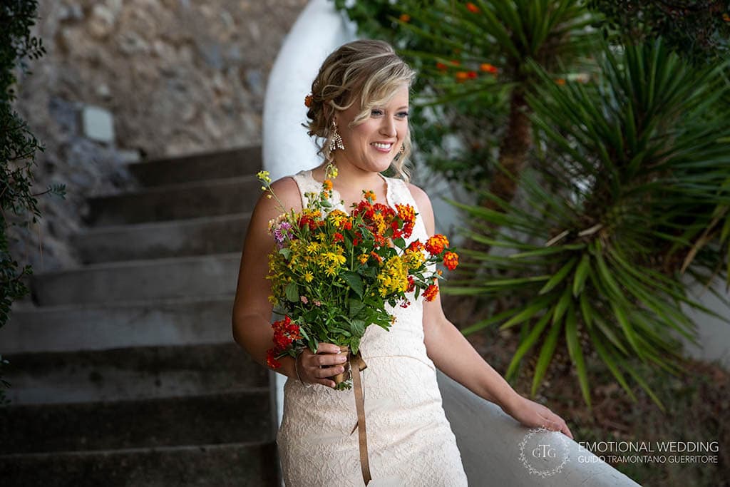 bride walking down the stairs to meet the groom for the elopement ceremony in Amalfi coast