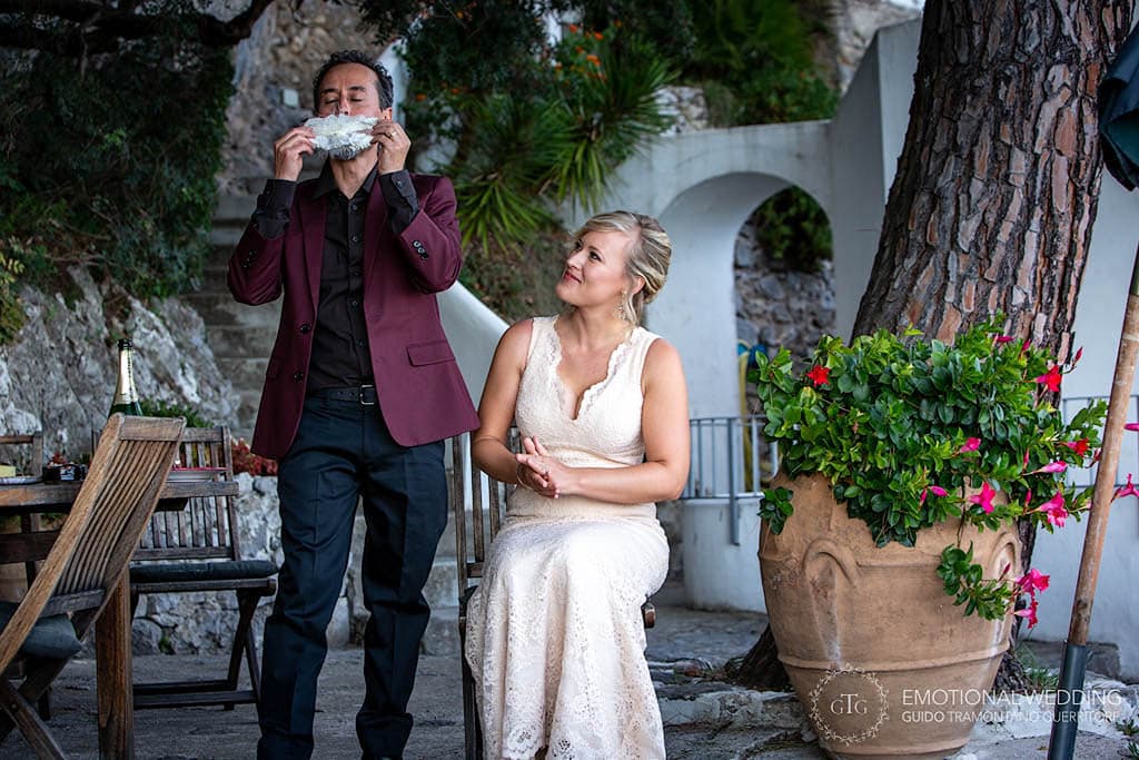 groom smells bride garter at their elopement in Amalfi Coast