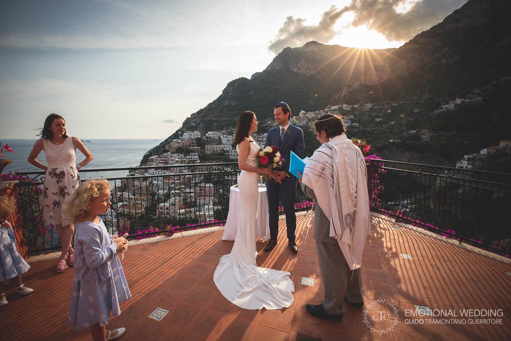 bride and groom during a ceremony at sunset in Positano
