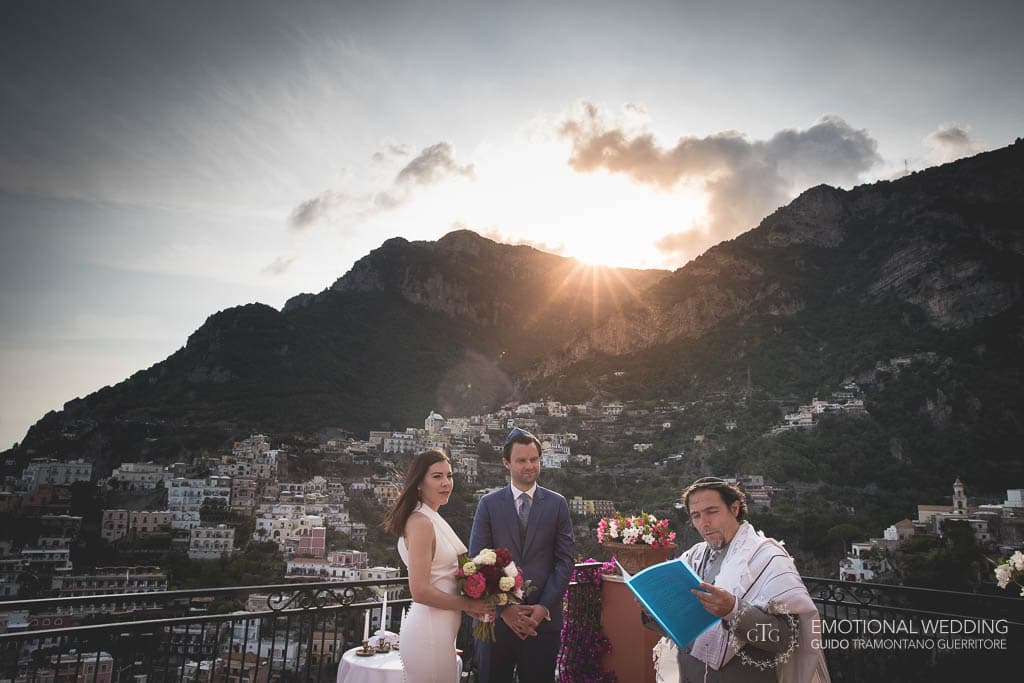 wedding couple and officiant during a wedding in Positano at sunset