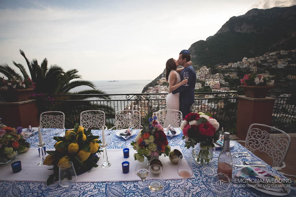 bride and groom kissing on the terrace at villa dei fisici at a wedding in Positano