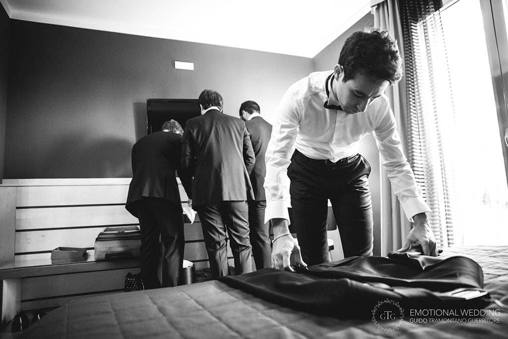 groom checking his jacket to get ready for his wedding in apulia