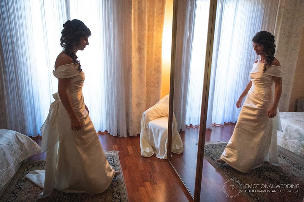 a bride and her reflection in the mirror at a wedding in apulia