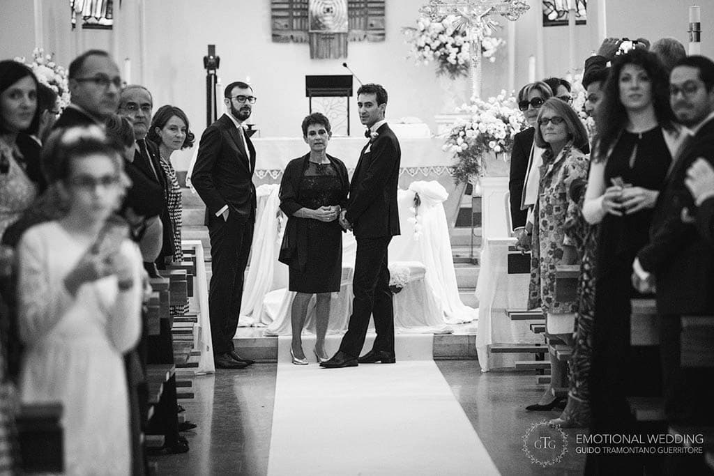 groom and his mother waiting for the bride inside the church at a wedding in puglia