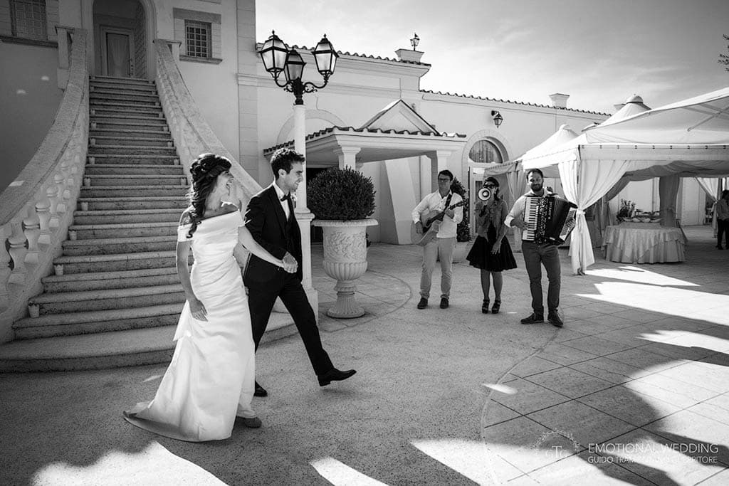bride and groom entering wedding reception at tenimento san Giuseppe in puglia