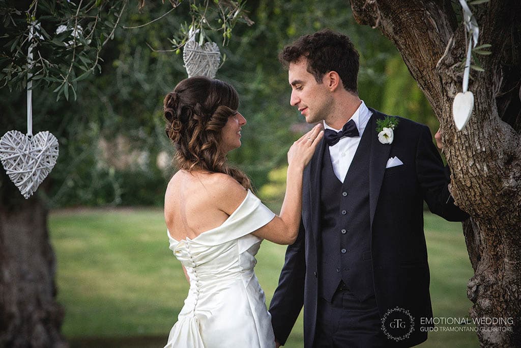candid of the bride and groom in the garden at tenimento san Giuseppe shot by a wedding photographer in puglia