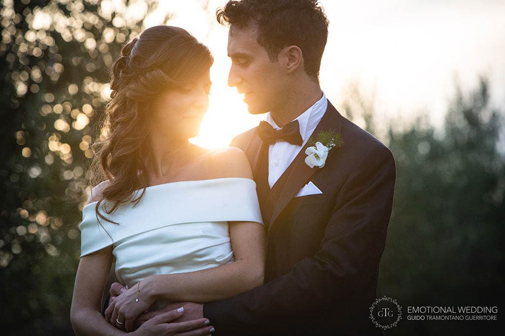 very romantic and candid shot against the light of the bride and groom taken by a wedding photographer in puglia