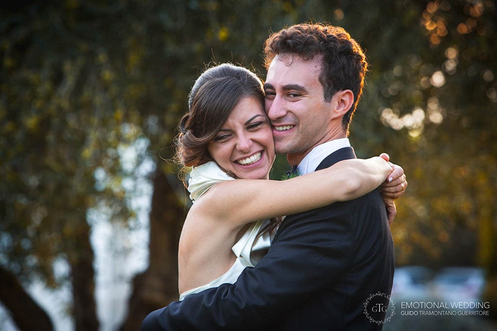 bride and groom smiling and hugging at their wedding party in apulia