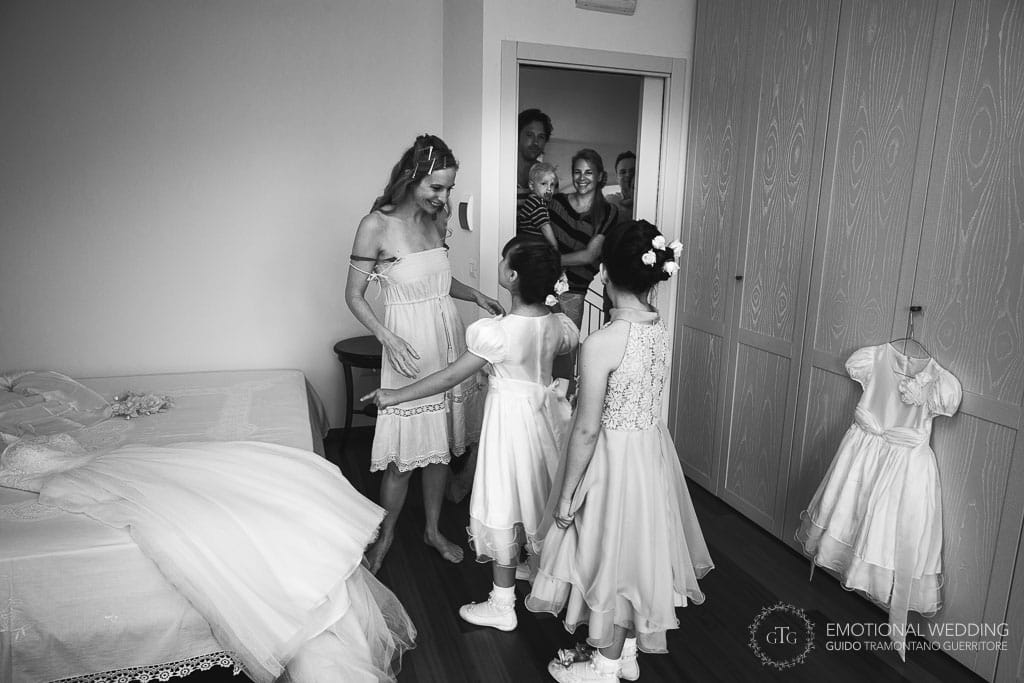 bride meets flower girls before getting ready for her wedding in cilento