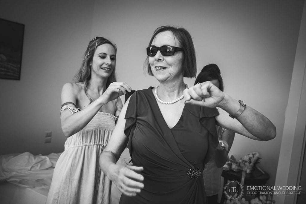 bride helps her mother getting ready for the ceremony
