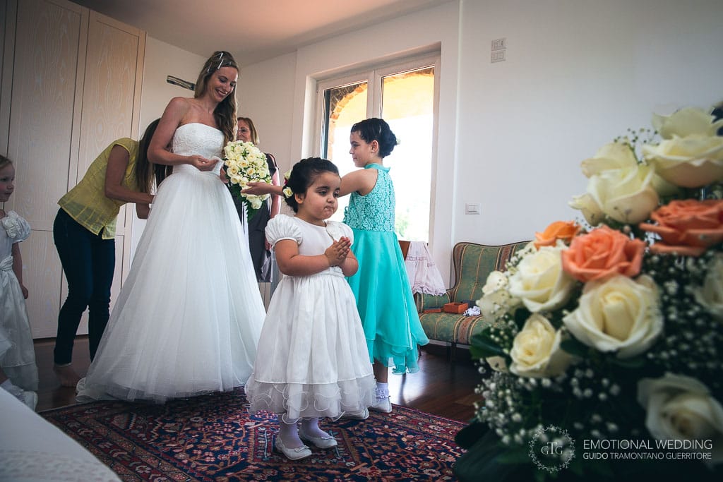 flower girls practicing her role while bride is getting ready