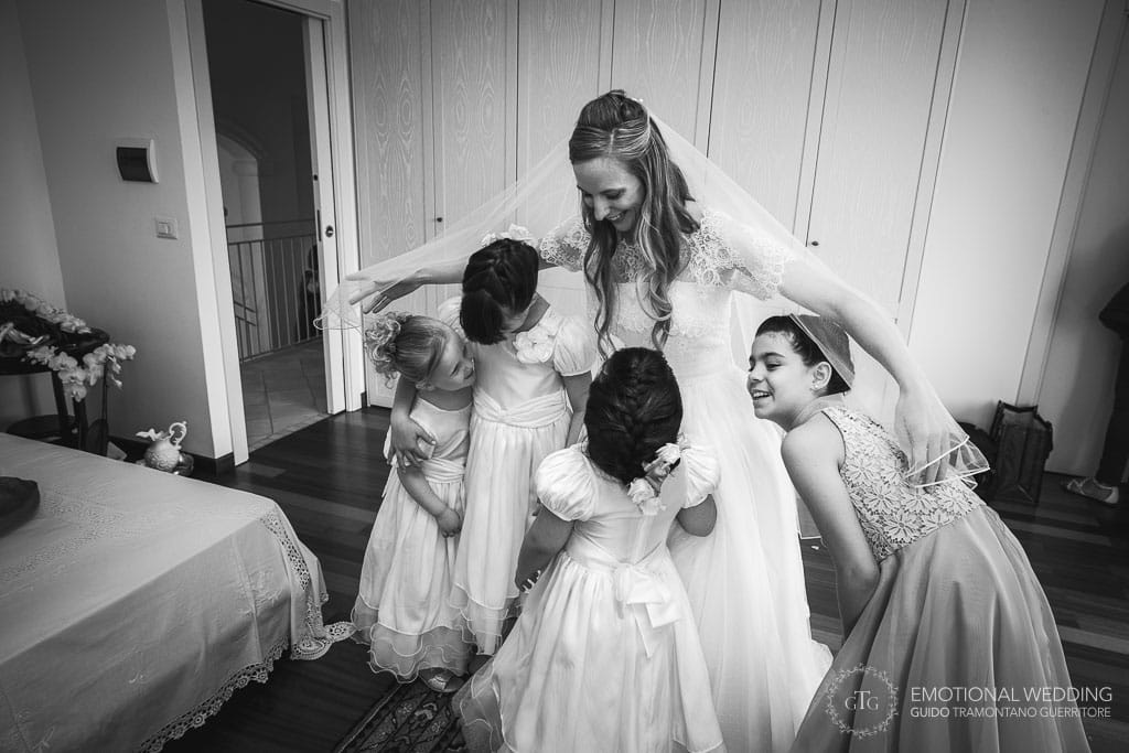 bride hugging four flower girls at a wedding in cilento