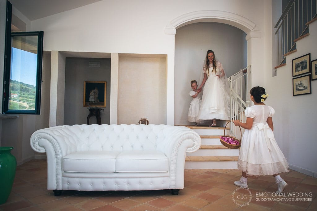 bride coming down the stairs with a flower girl at a wedding in cilento