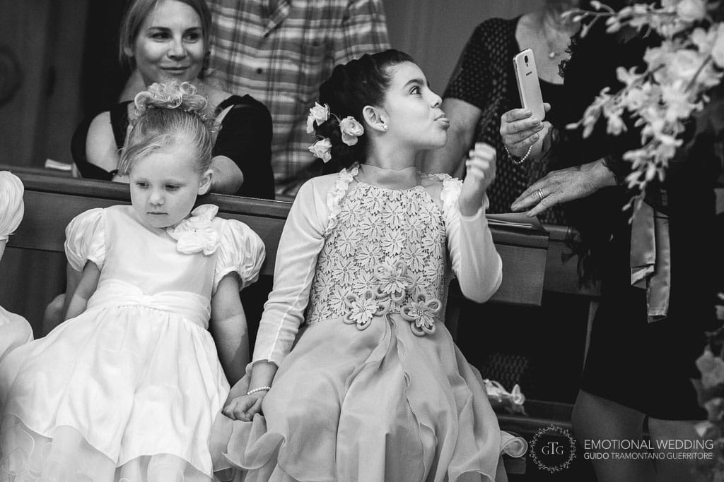flower girl makes a funny face in the church at a wedding in cilento