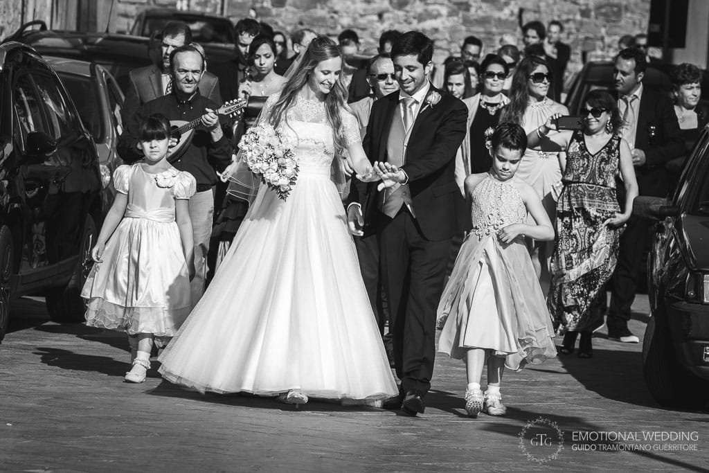 wedding couple and their guests walking in the street at a wedding in cilento