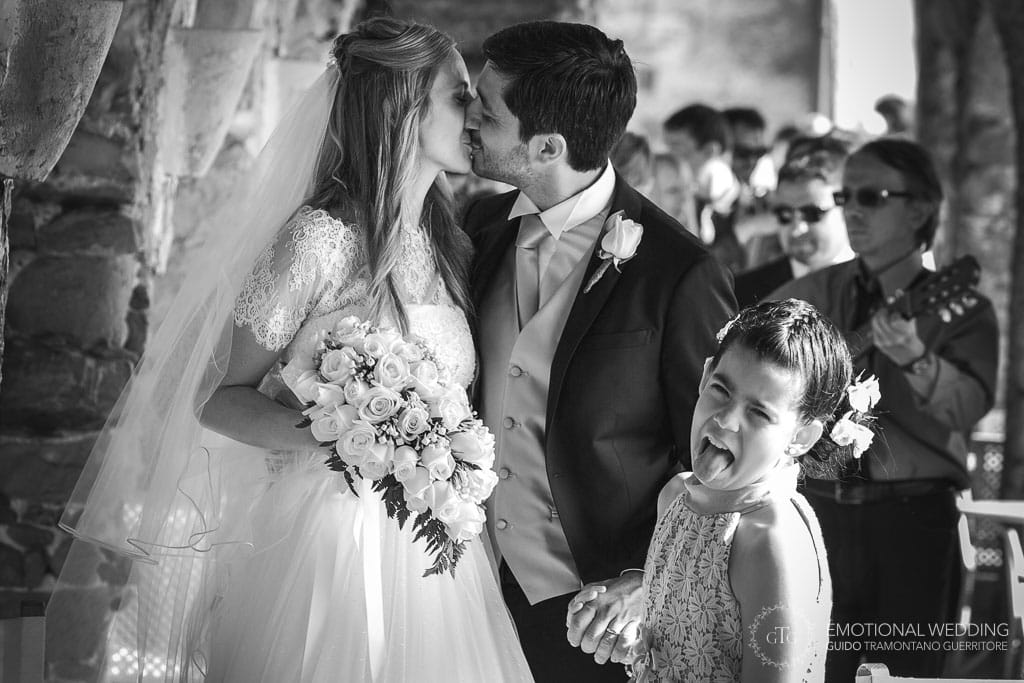 a flower girl showing her displeasure for a kiss of the bride and groom at a wedding in cilento