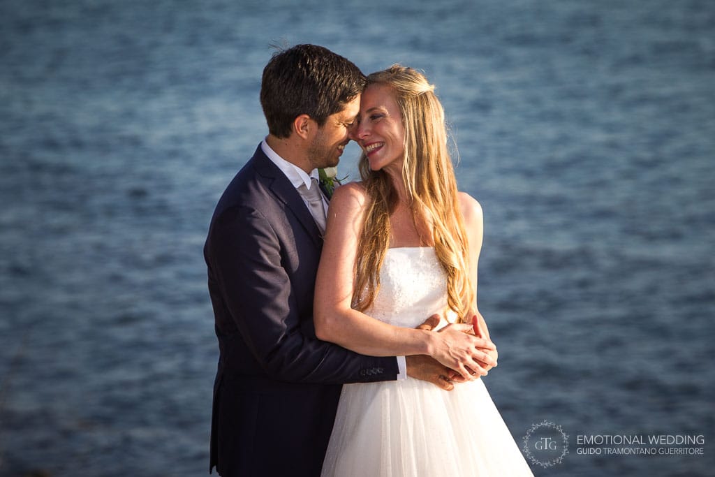 romantic moment of a wedding couple in Cilento and the sea in the background