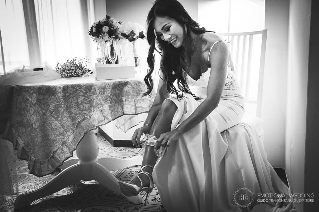 bride of a mixed wedding couple wearing her shoes