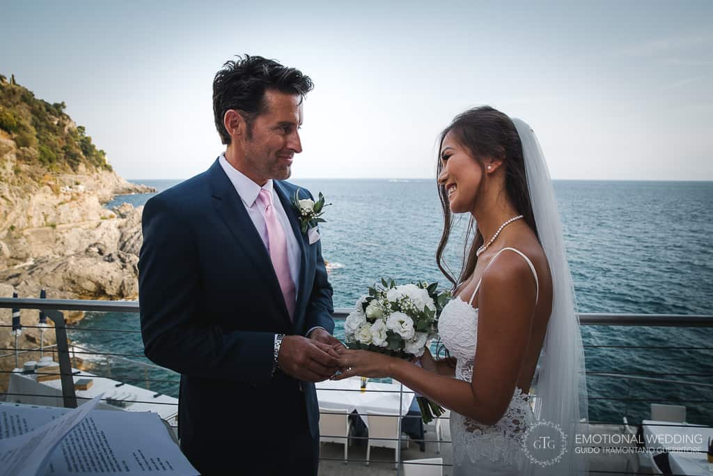 mixed wedding couple ring exchange at Torre Normanna in Amalfi coast