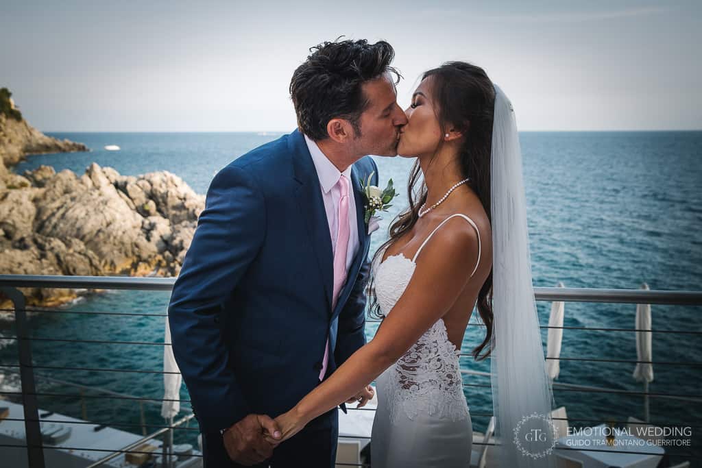 mixed wedding couple kissing at their ceremony in Amalfi coast