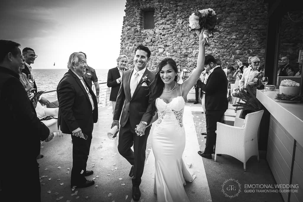 mixed wedding couple exit toss at the Torre Normanna in Amalfi coast