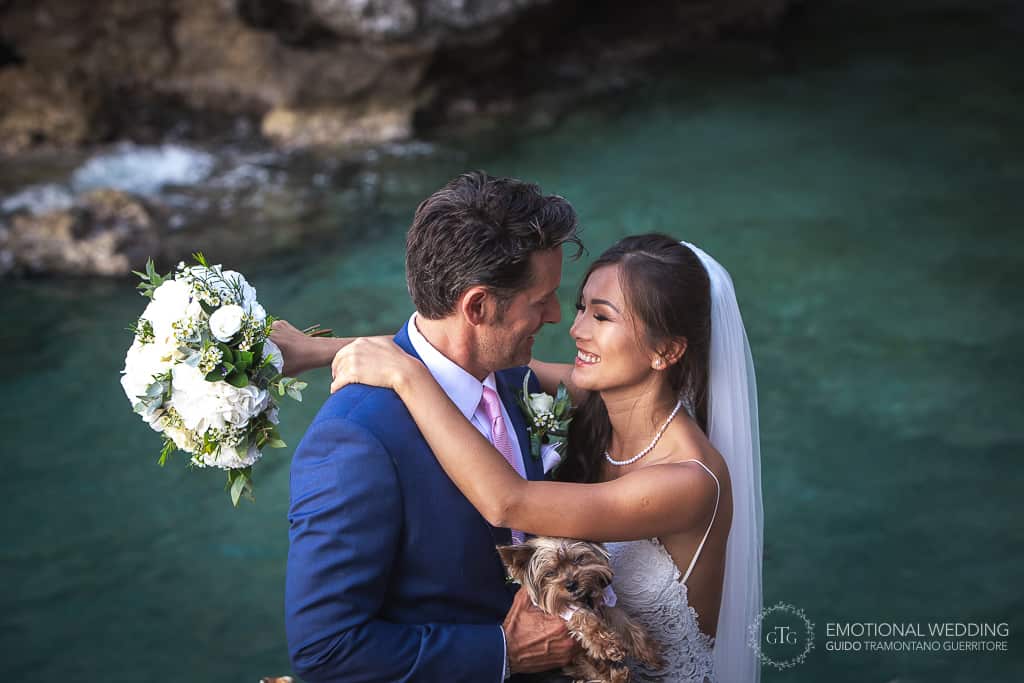 mixed wedding couple portrait on a crystal clear water background in Amalfi coast