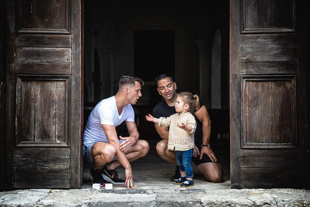 a gay couple and their little daughter before their ceremony