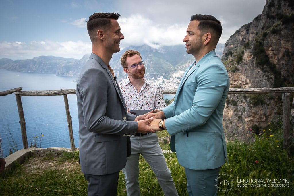 same sex couple and officiant celebrating the ceremony