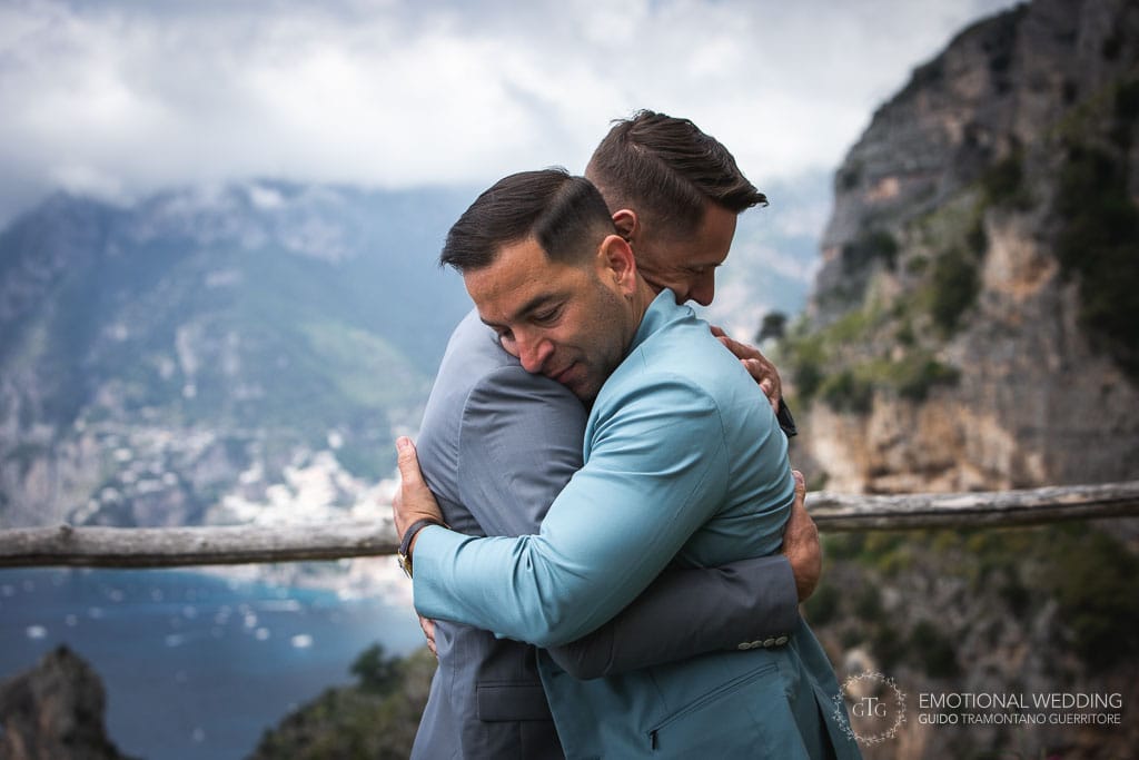 gay couple hug after ceremony at the path of gods in Amalfi Coast