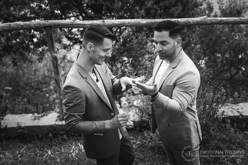 gay couple looking at their wedding rings
