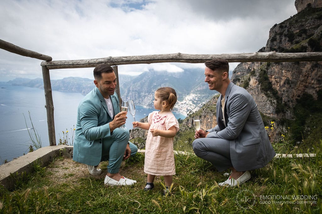 gay couple cheering with their daughter after ceremony