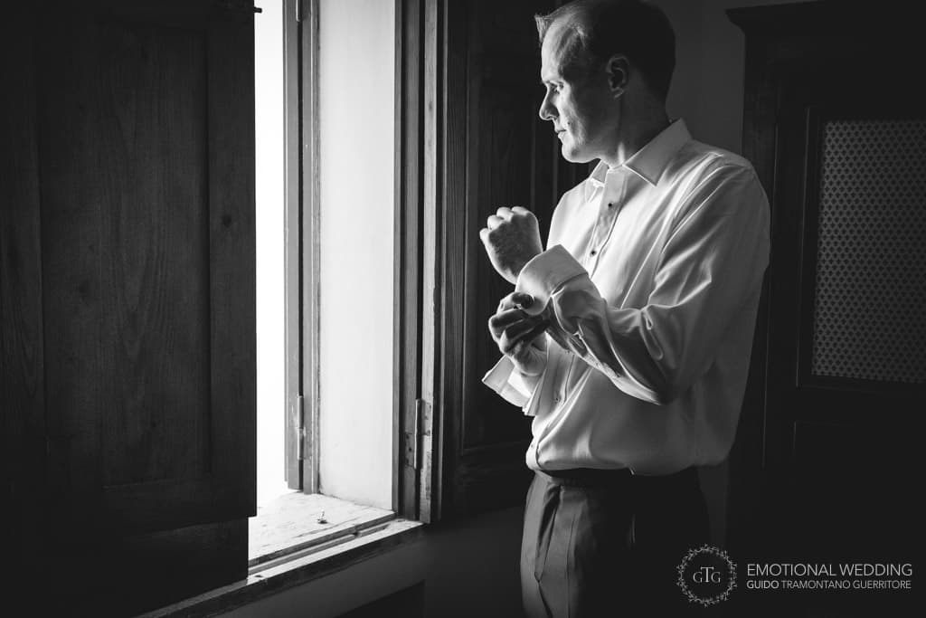 groom getting ready looking out of the windows in his room at villa Scarpariello in Amalfi coast