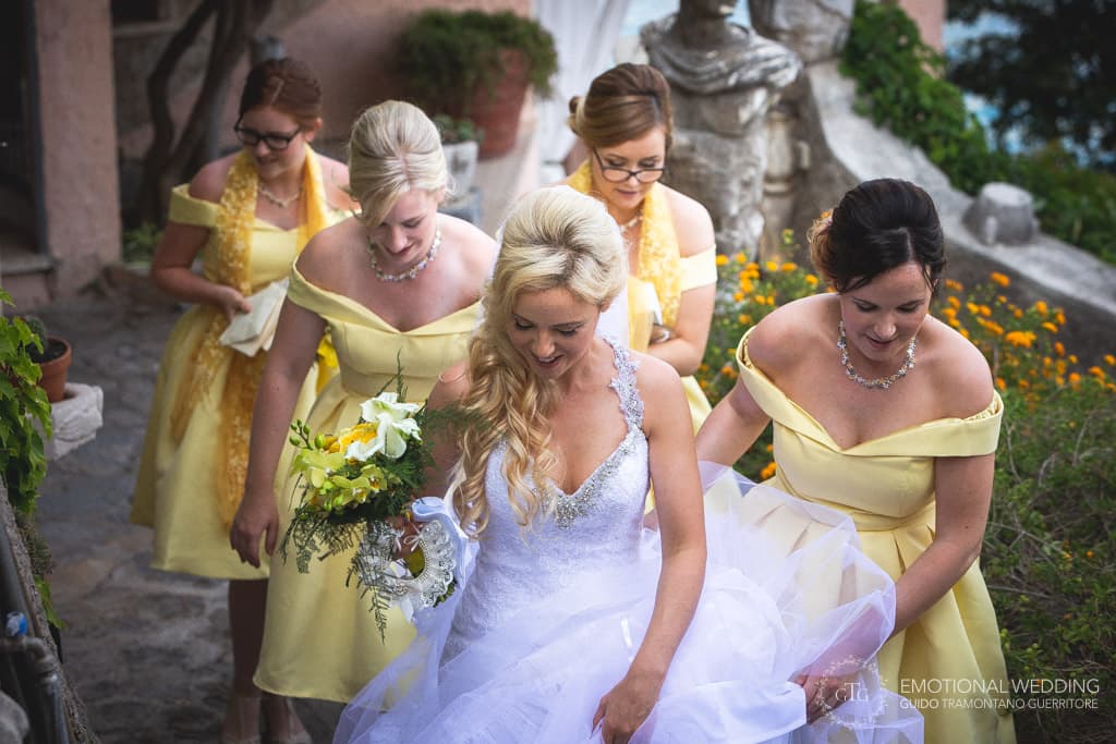 bridesmaids follow the bride as she exits villa scarpariello