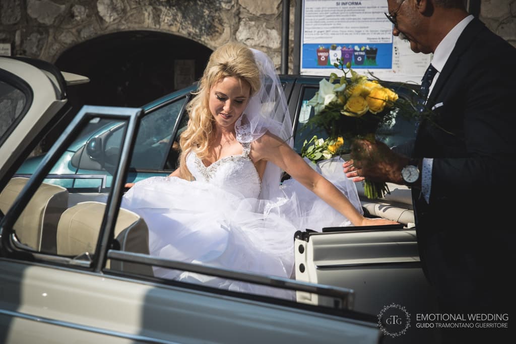 bride getting out of the car at the church in Amalfi Coast