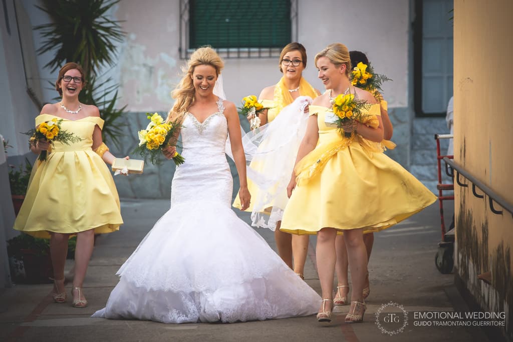 bride and bridesmaids laugh while walking to the church at a wedding in Praiano, Amalfi coast