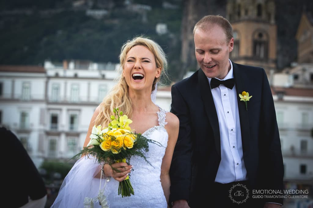 irish bride laughing while walking on the Amalfi pier in Amalfi coast