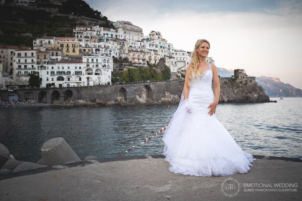 portrait of an irish bride on the Amalfi pier with Atrani in the background