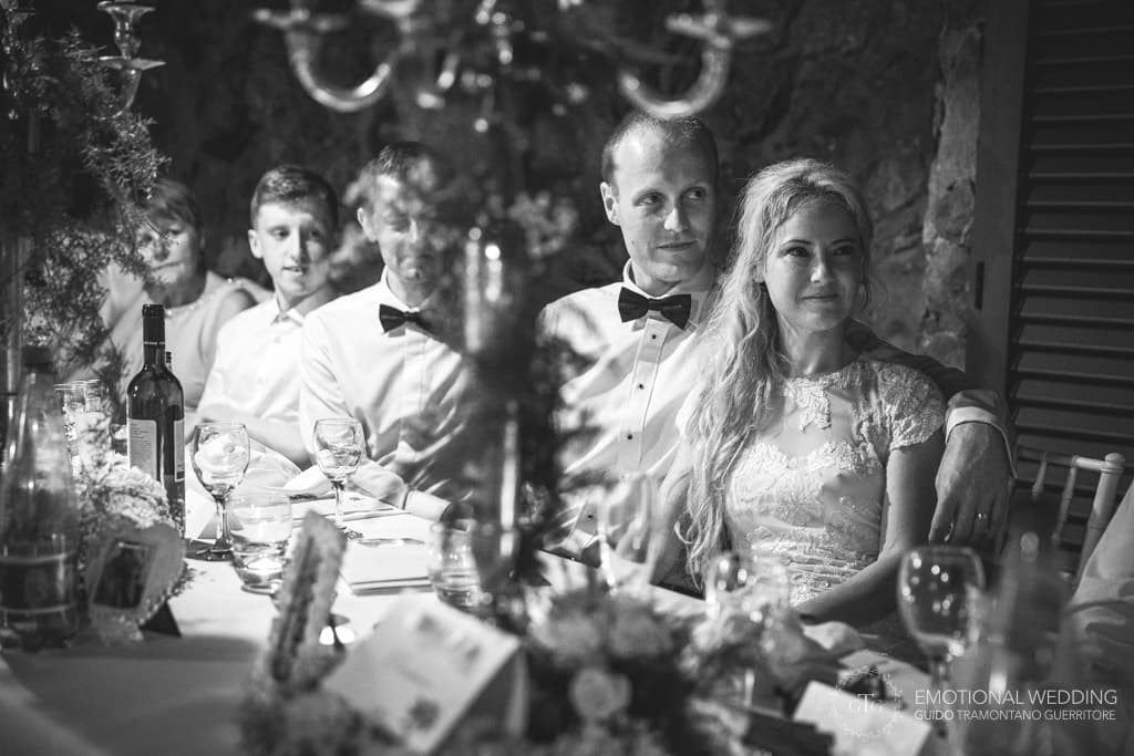bride and groom listening speeches at wedding party at villa scarpariello