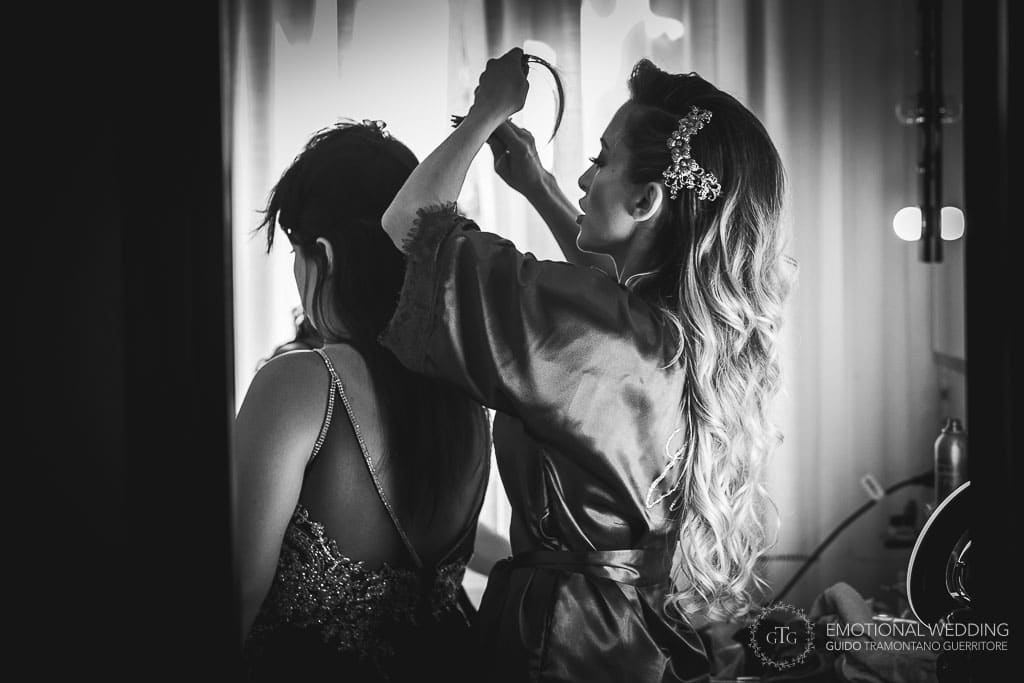 bride helps her sister getting ready