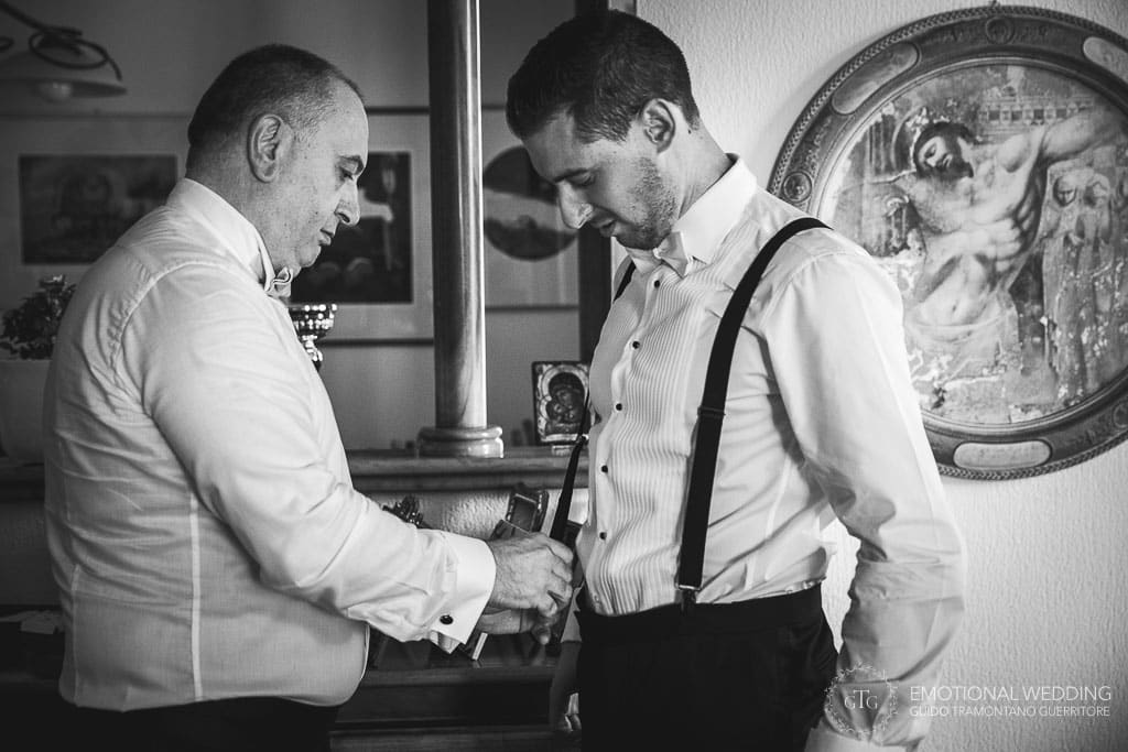 groom wearing braces at a destination wedding in Fidenza