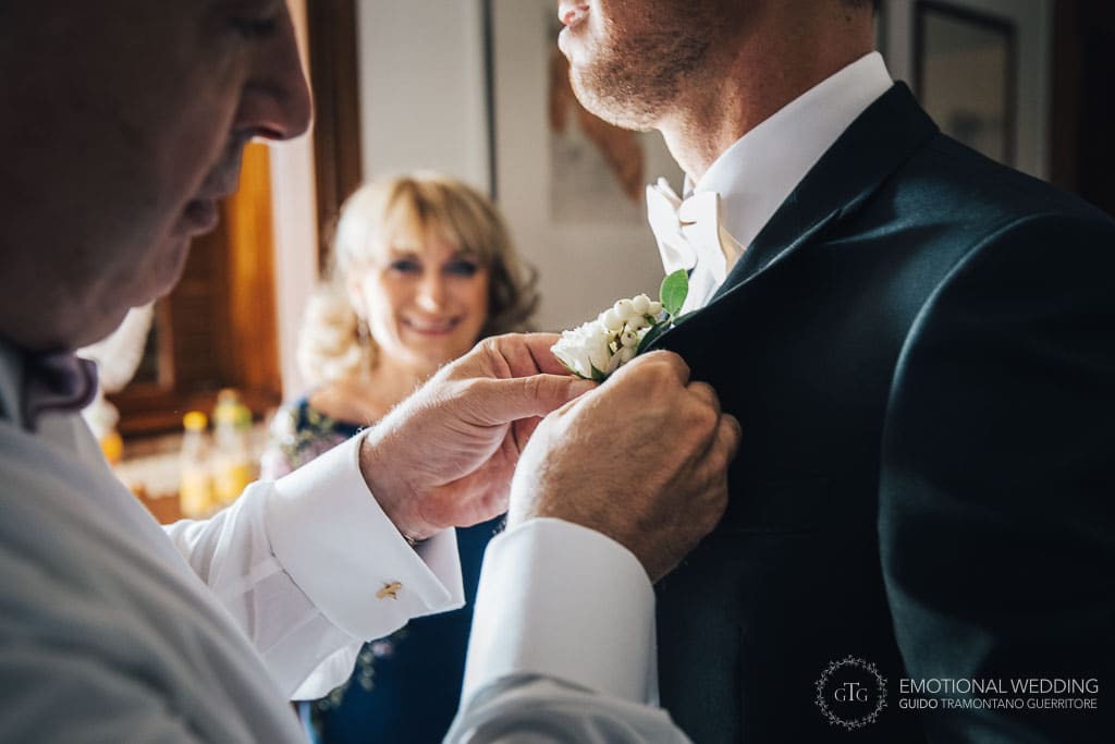 father of the groom helps him getting ready