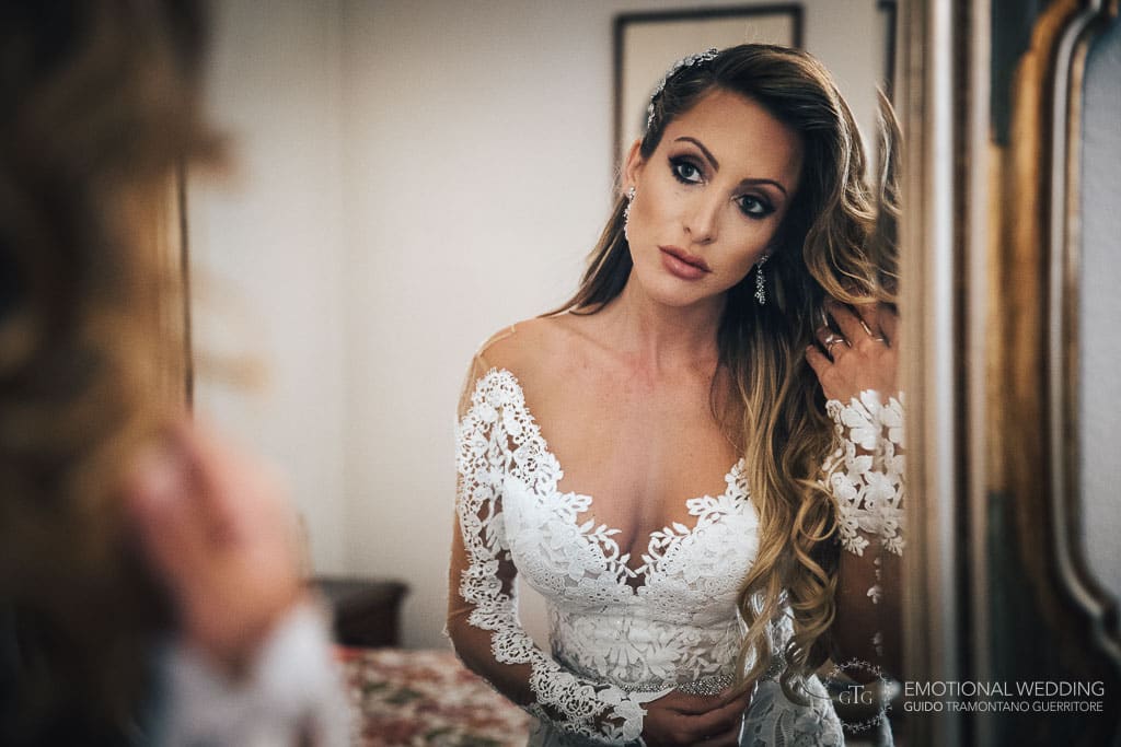 bride looks into the mirror