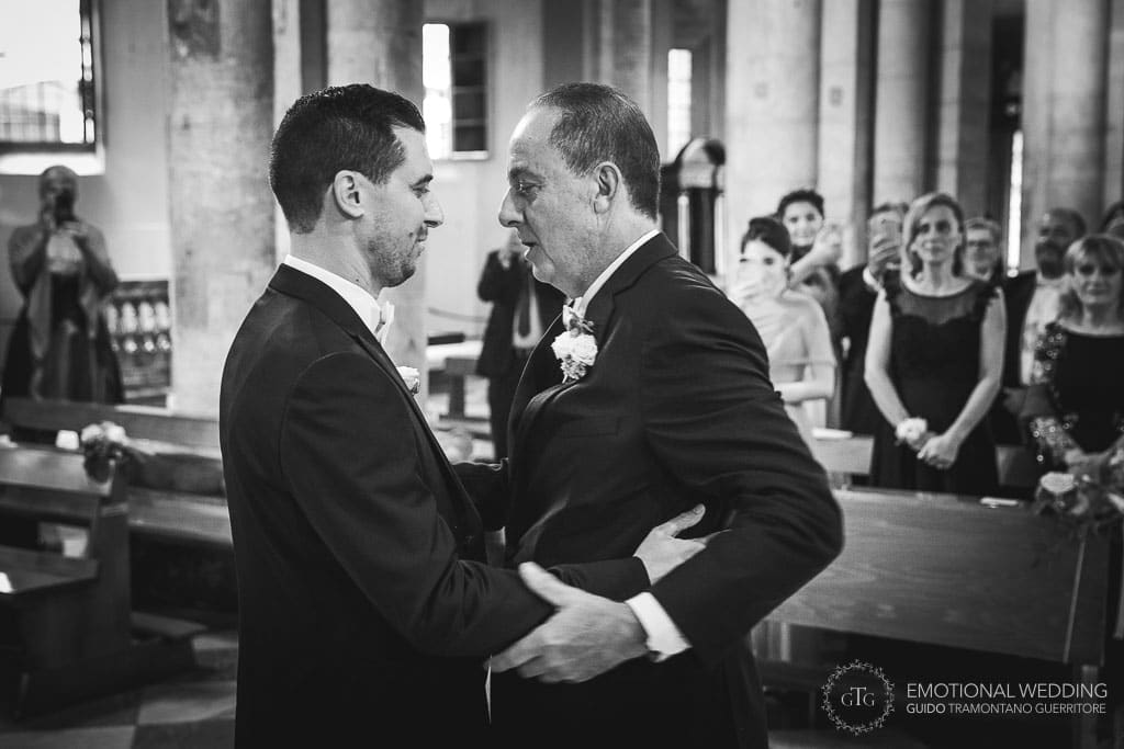 groom meets the bride's father in the church