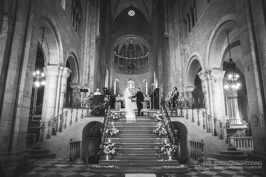 bride and groom walk to the altar in the church for the ceremony