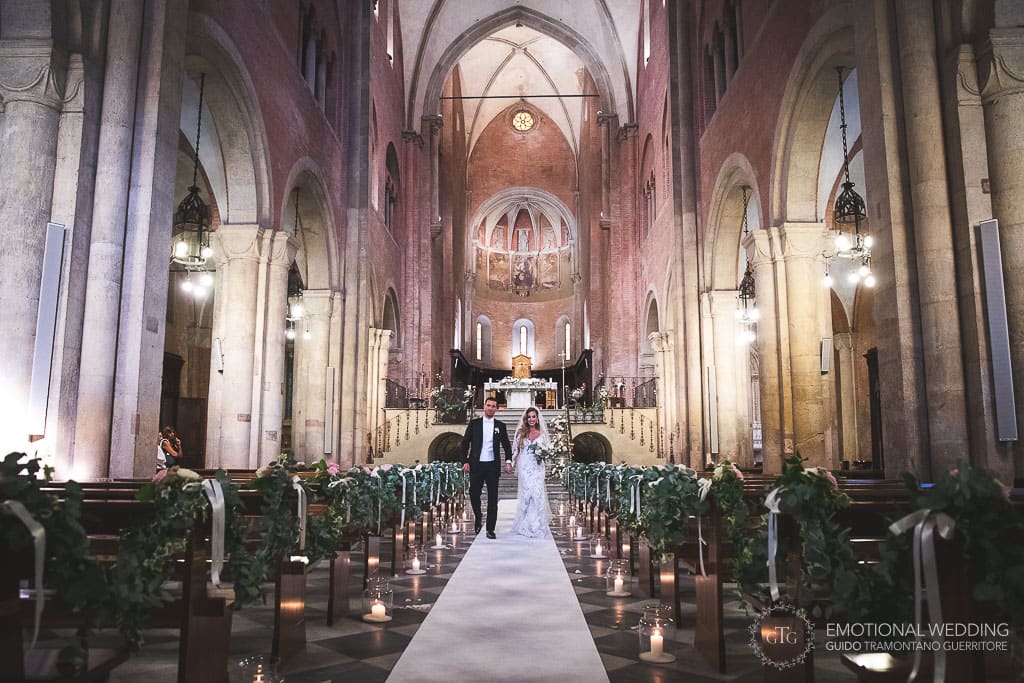 bride and groom walking out of the fidenza cathedral