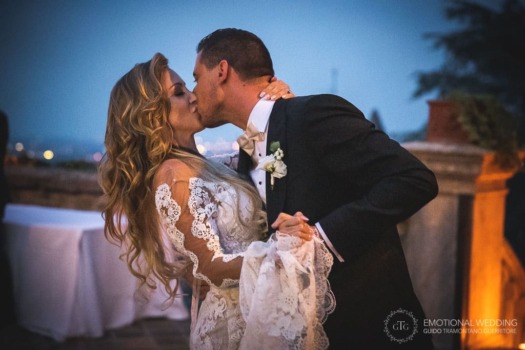 bride and groom kissing at their first dance
