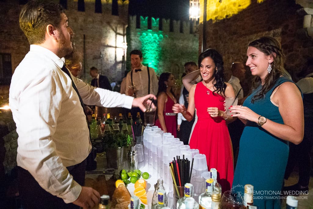 bartender gives drinks to guests at wedding party