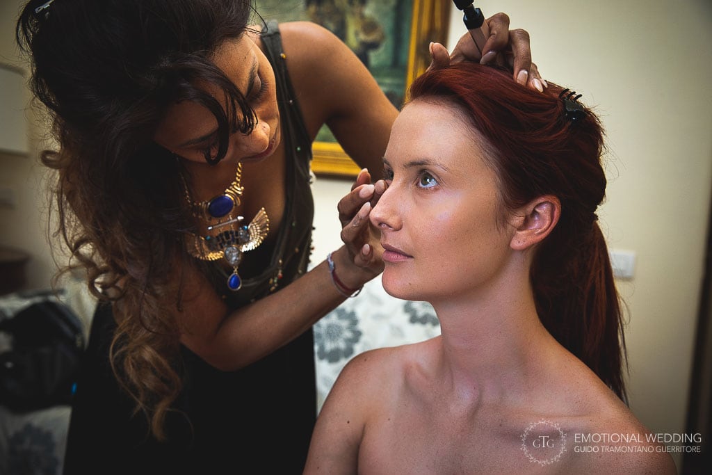 bride and makeup artist getting ready for wedding ceremony in ravello, italy