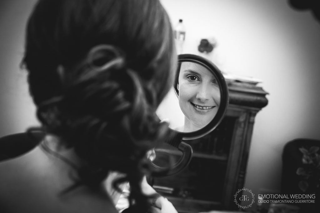 bride looking in the mirror while getting ready for her wedding ceremony in ravello