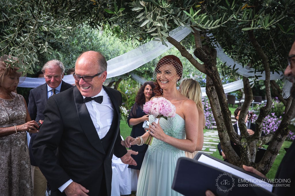 father of the bride welcomes the groom at a wedding ceremony in ravello, italy